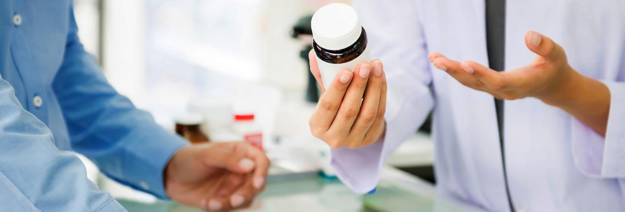 Pharmacist speaking with a patient about a prescription