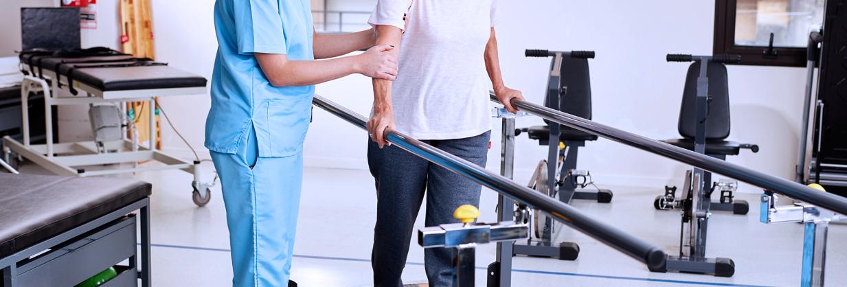 Healthcare worker assisting a patient with a rehabilitation excercise