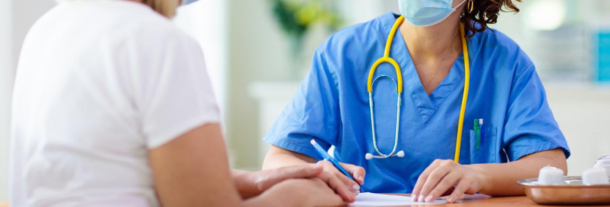 Healthcare worker completing a form with a patient