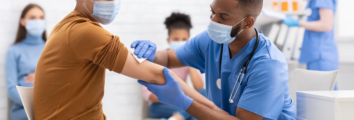 Healthcare worker prepping a patient's arm for an injection