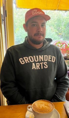 man with red hat and dark hoodie