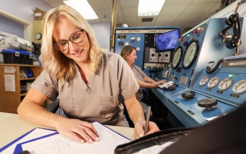 a photo of a woman with blonde hair in a room with respiratory machines.